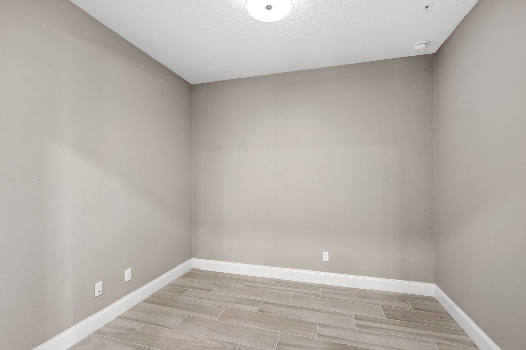 empty room with brown walls and wood plank floors